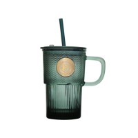 Classic green colored glass cup with straw